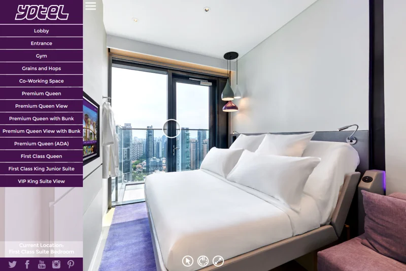 Hotel room virtual tour at Yotel Singapore Orchard showing bedroom with pendant lamps and illuminated city skyline