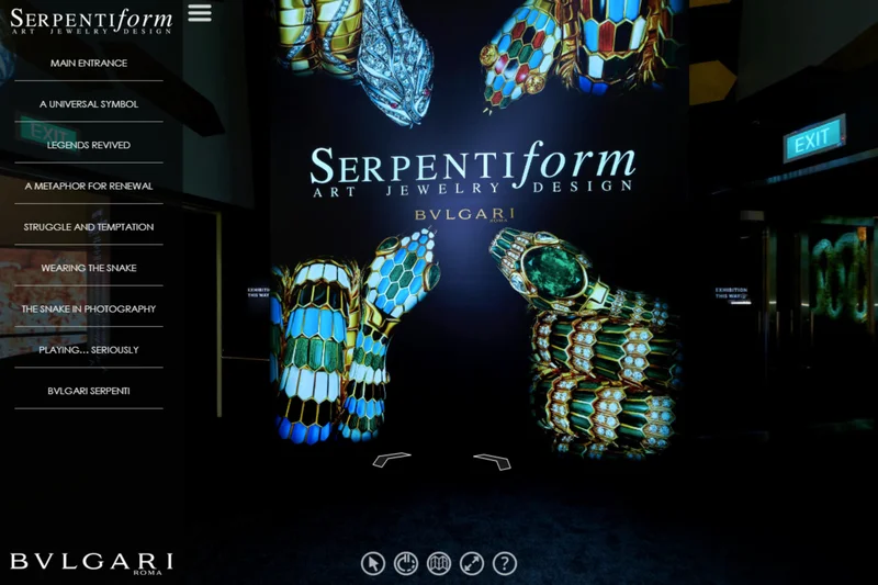 Virtual tour entrance showing large backlit wall graphic of jewelled snake bracelets with exhibition title and navigation menu
